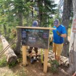 Installing the trail map for our new trail high on Uleda Ridge